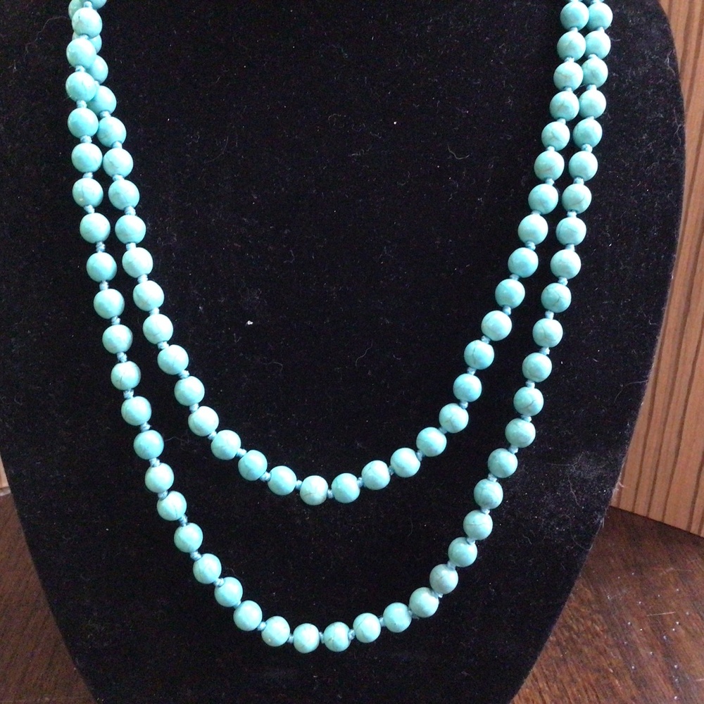 Long strand of dyed howlite.